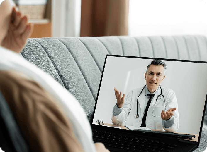 Doctor having video consultation with patient on laptop